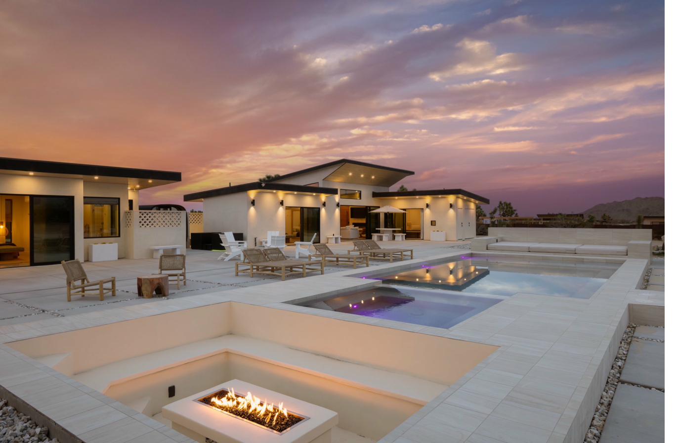 Pool, firepit, and both homes at golden hour