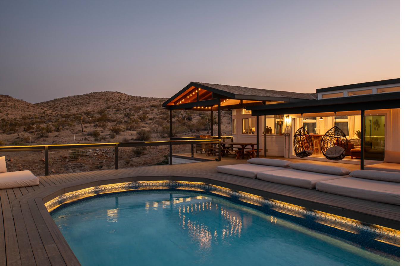 Pool lit at dusk with canyon silhouettes
