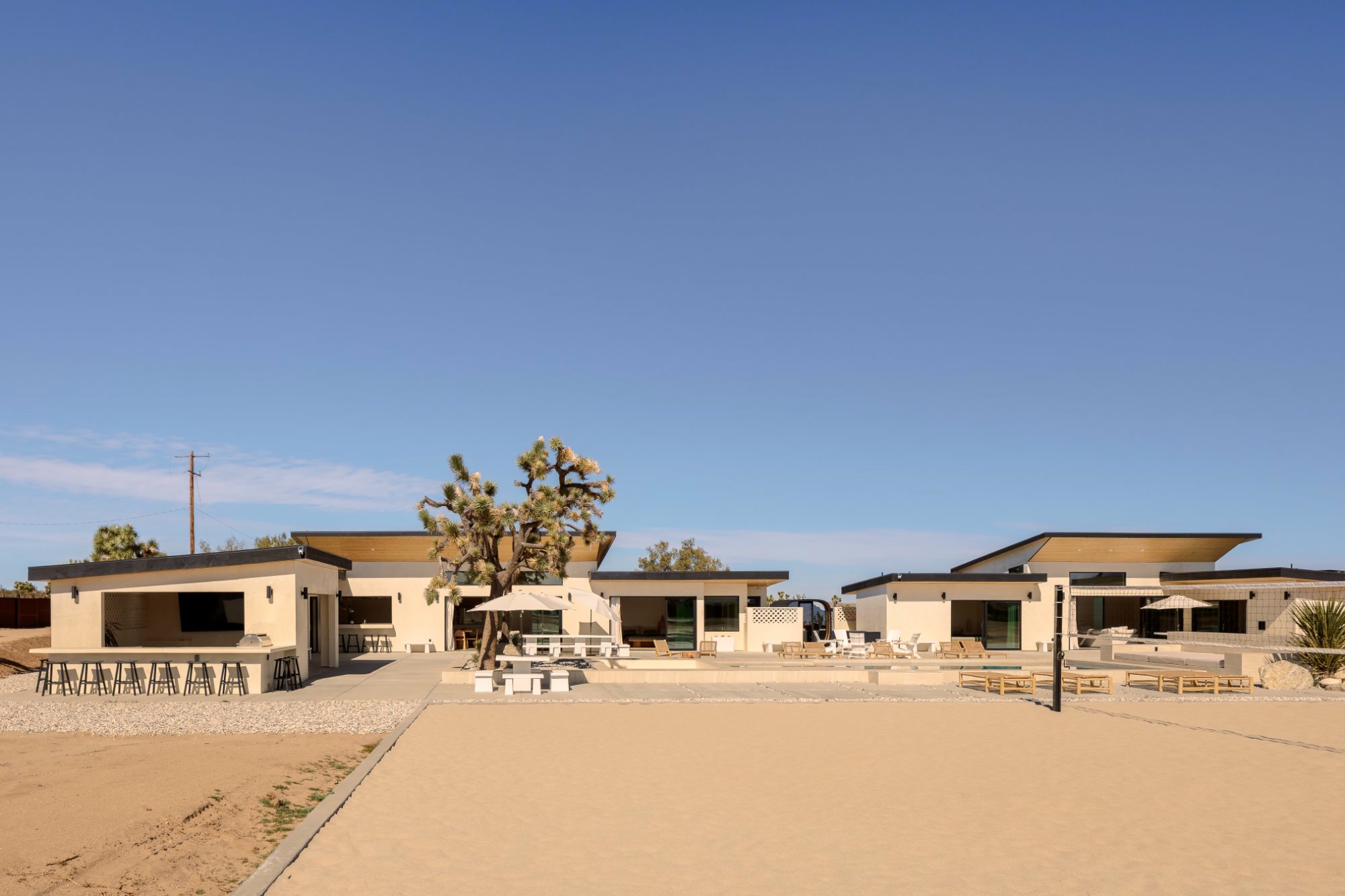 Sand court with both homes in the background